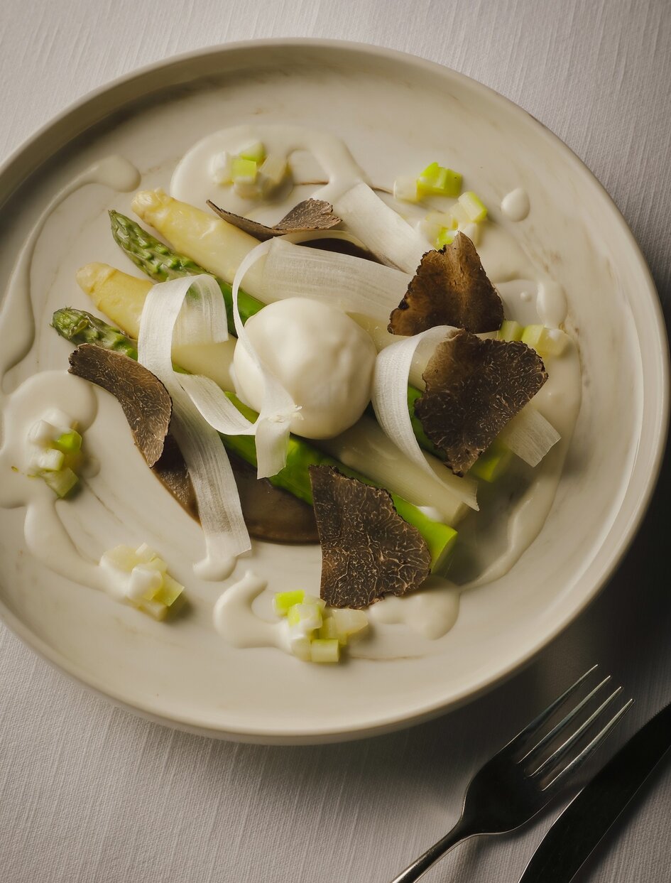 Plated dish at Aman Tokyo featuring seared fish with creamed sauce and microgreens, spring 2026.