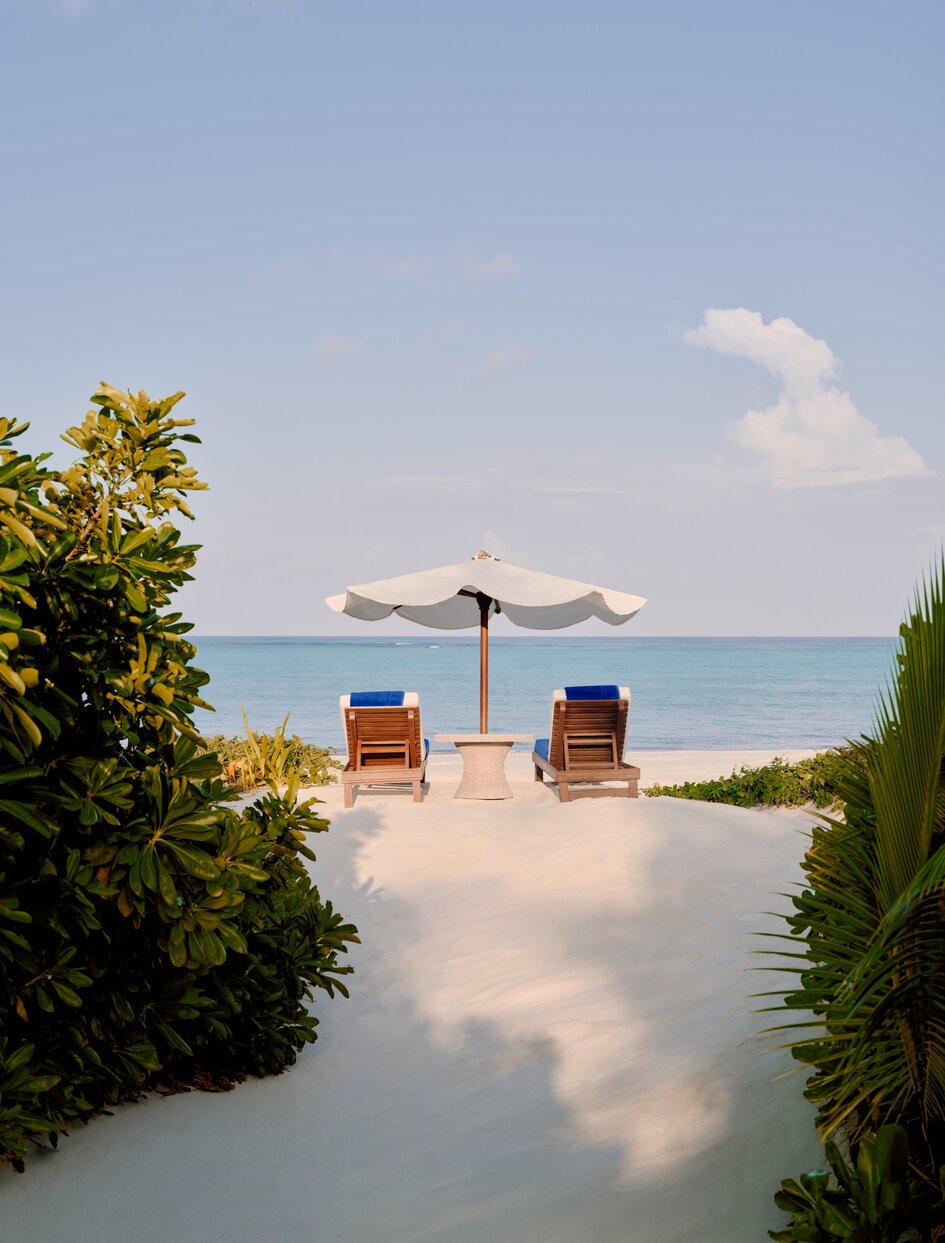 Grand Beach Pool Casita at Amanpulo, Philippines, with two loungers facing the turquoise sea.