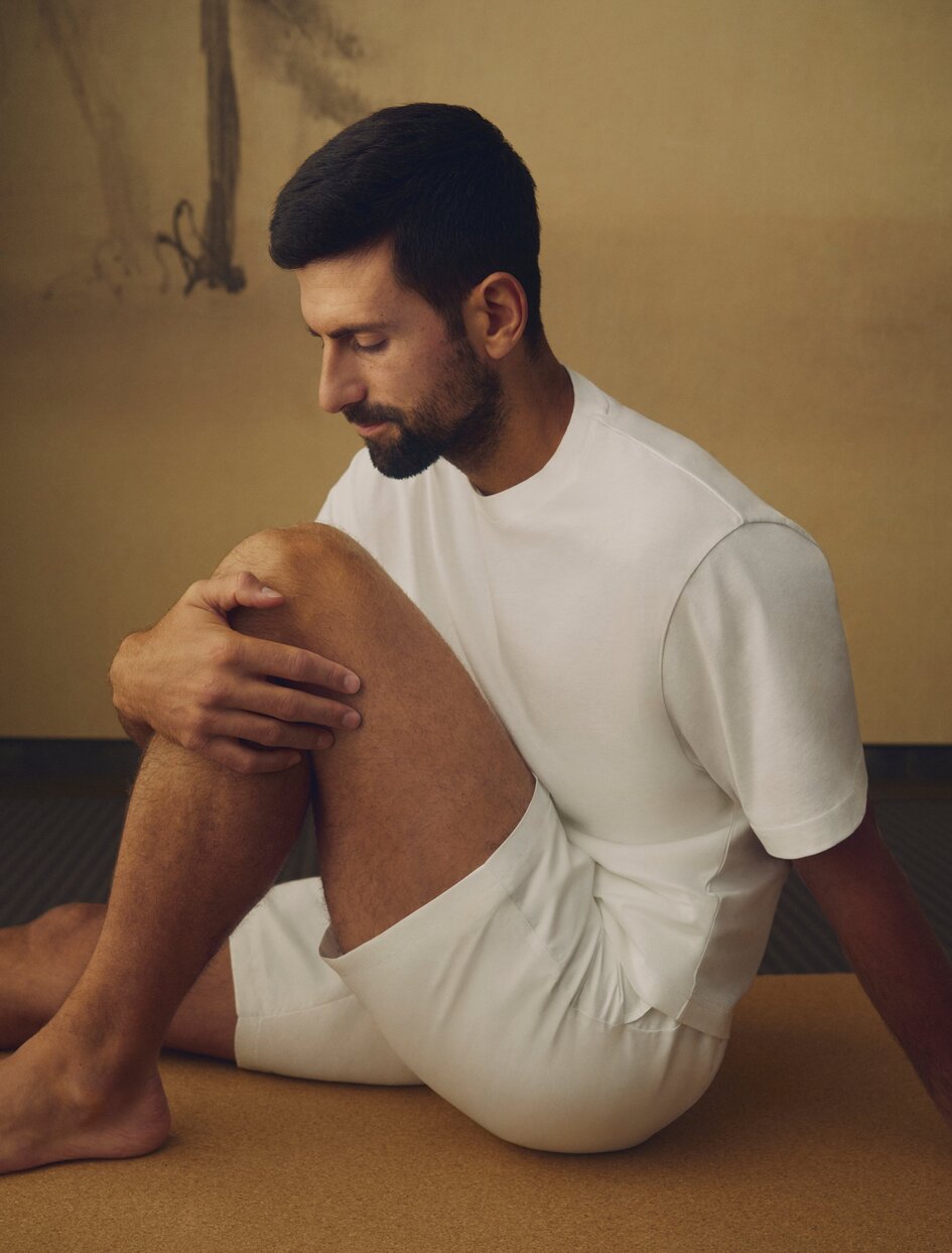 Novak Djokovic, brand ambassador, seated in contemplative pose at Aman Nai Lert Bangkok.
