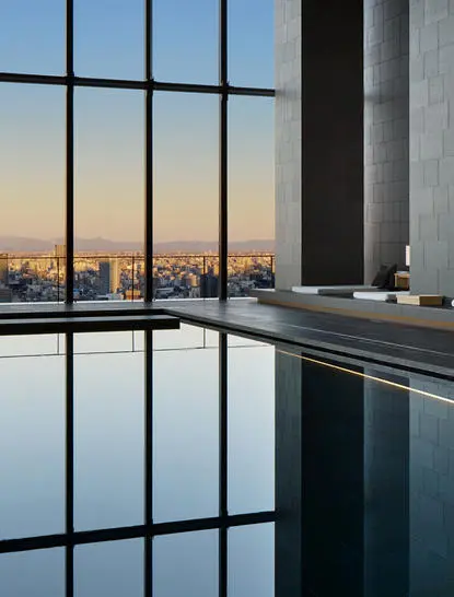 Plunge pool overlooking Tokyo cityscape at sunrise, Aman Tokyo hotel.