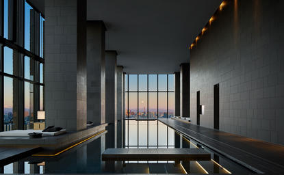 Gallery corridor at Aman Tokyo with floor-to-ceiling windows overlooking the city skyline.