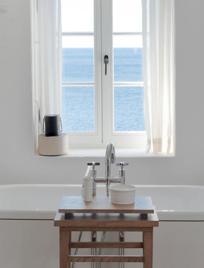 Adriatic Sea view through white double doors and windows in principal bathroom at Aman Sveti Stefan.