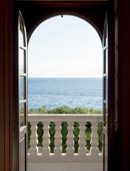 Adriatic Sea view from Aman Sveti Stefan suite terrace, framed by an open archway.