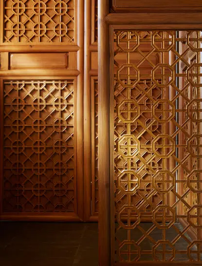 Carved wooden doors with geometric Islamic patterns at Amandayan.