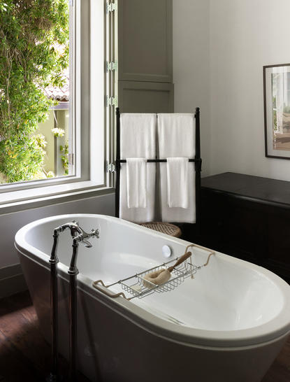 Principal bedroom at Amangalla with freestanding bathtub and garden views.