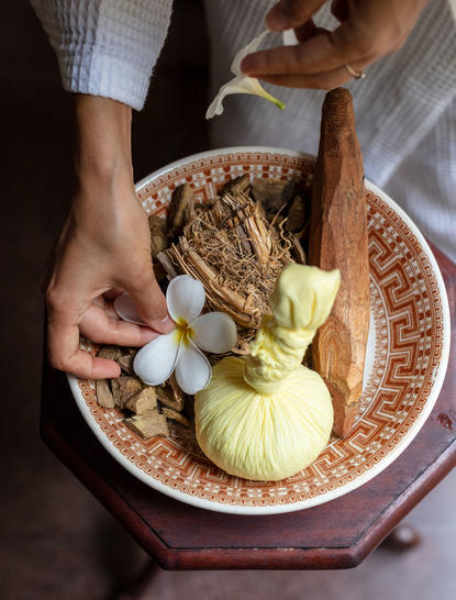 Woven basket holding sliced custard apple and flowers at Amangalla wellness experience.
