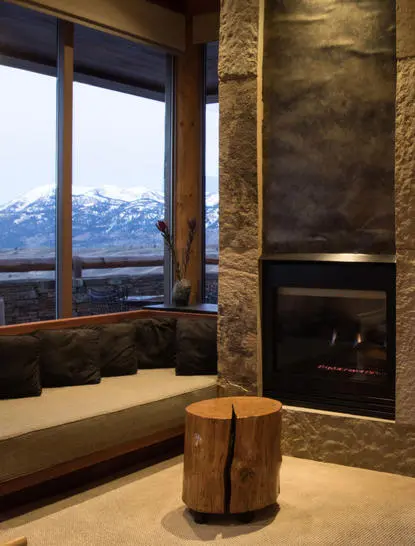 Shoshone Suite bathroom with soaking tub, fireplace, and mountain views at Amangani.