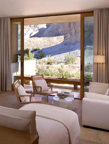 Principal bedroom seating area at Amangiri with expansive mesa views through floor-to-ceiling windows.