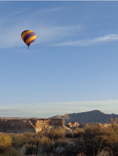 Hot air balloon floating above desert landscape at Amangiri resort.