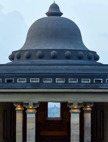 Amanjiwo resort's domed pavilion with classical columns and blue sky backdrop.
