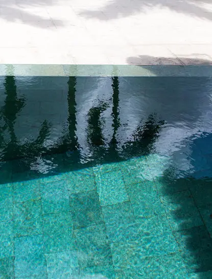 Plunge pool at Amanjiwo resort overlooking turquoise waters and distant mountains.