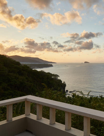 Indrakila Suite balcony overlooking the Bali coastline at sunset, Amankila resort.