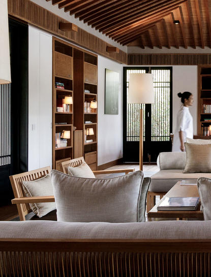 Three-bedroom residence lounge at Amanoi, featuring cream seating and wooden ceiling details.