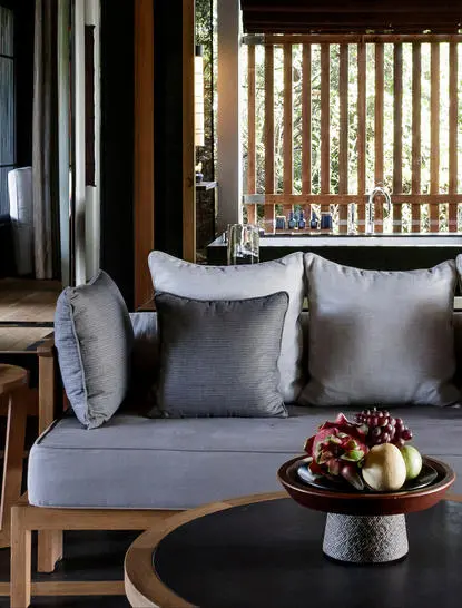 Mountain Pavilion seating area with grey daybed and cushions at Amanoi resort.