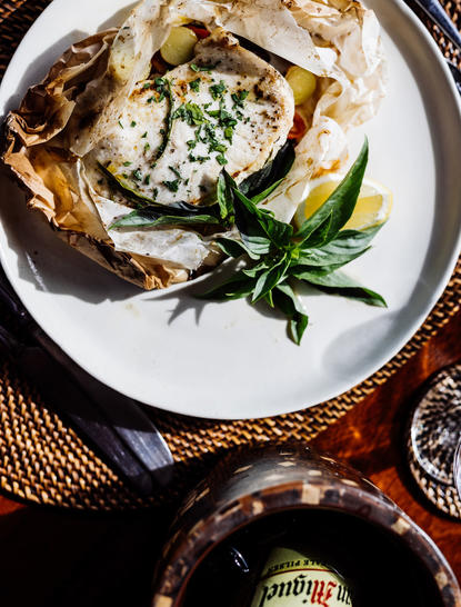 Oyster topped with herbs and garnish at Amanpulo's Beach Club dining venue.