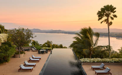 Villa infinity pool overlooking Phang Nga Bay at Amanpuri resort, Thailand, at dusk.