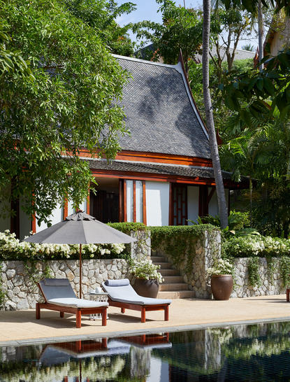 Three-bedroom garden villa with modern architecture, reflecting pool, and lounge area at Amanpuri.