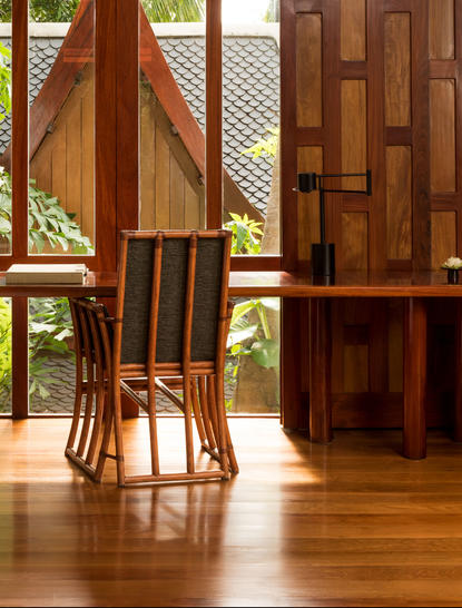 Deluxe Ocean Pavilion interior with wooden furniture and geometric wall panels at Amanpuri.