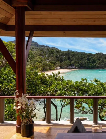 Ocean Pavilion at Amanpuri resort with views over turquoise waters and forested coastline.