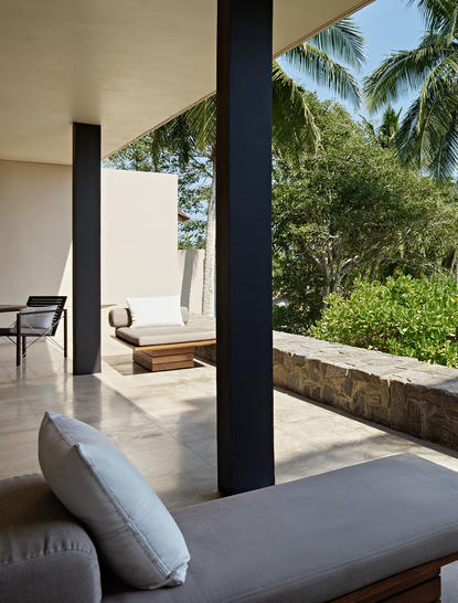Ocean Pool Suite at Amanwella with daybed, supporting columns, and tropical views.