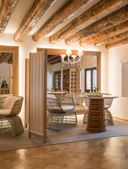Wellness space at Aman Venice with wooden beams, comfortable seating, and natural light throughout the hotel.