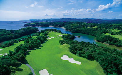Golf course at Amanemu resort with fairways, bunkers and water features surrounded by forested hills, Japan.