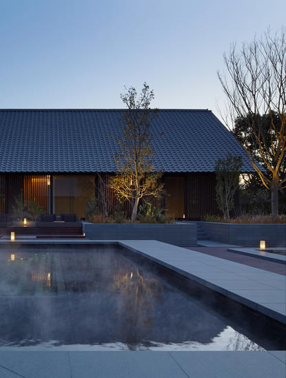 Outdoor spa with illuminated plunge pool at dusk, Amanemu resort, Japan.