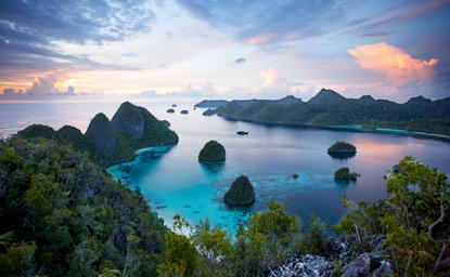 Turquoise waters and limestone islands at Amandira, Raja Ampat, at dusk.