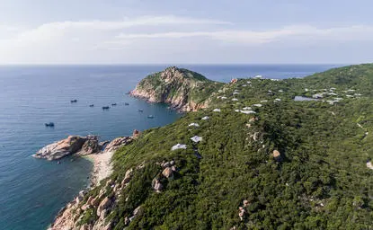 Aerial view of Amanoi resort nestled on a verdant coastal peninsula overlooking the turquoise waters of Vinh Nha Trang.