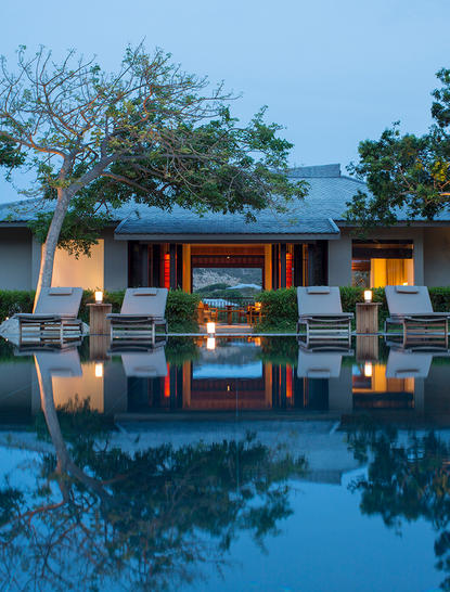 Three-bedroom residence with infinity pool reflecting evening light at Amanoi.