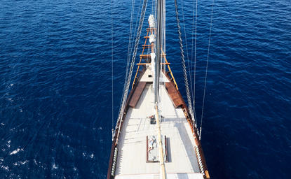 Sailing yacht's bow extending into deep blue waters at Amandira.