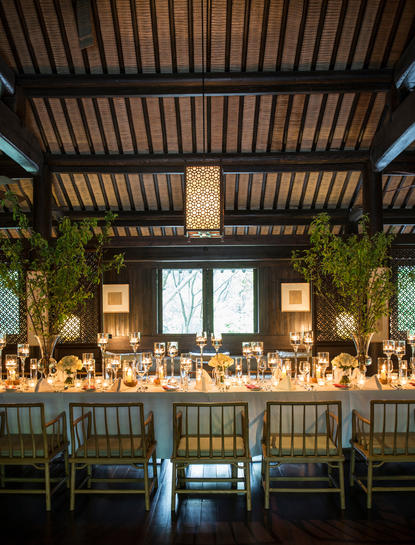 Amanfayun dining venue with slatted wooden ceiling, bar seating, and soft ambient lighting.