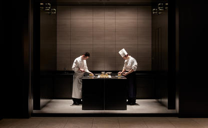Two chefs preparing pastries at a counter in La Patisserie at Aman Tokyo.