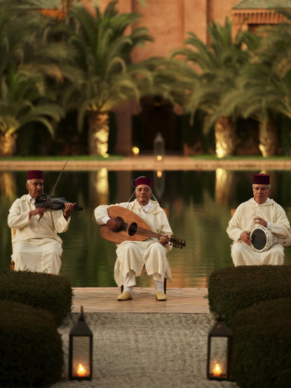 Musicians perform in the courtyard at Amanjena, Morocco, at dusk.