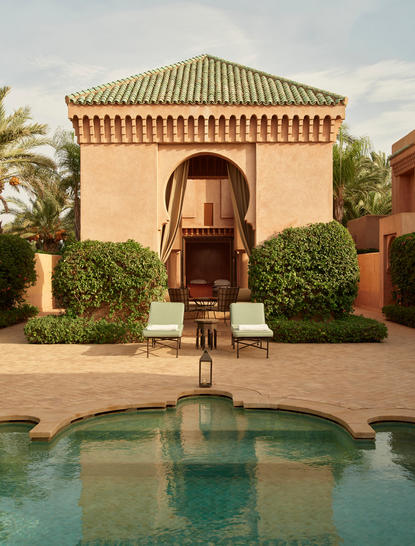 Amanjena pavilion with plunge pool reflecting the terracotta façade and traditional Moroccan architecture.