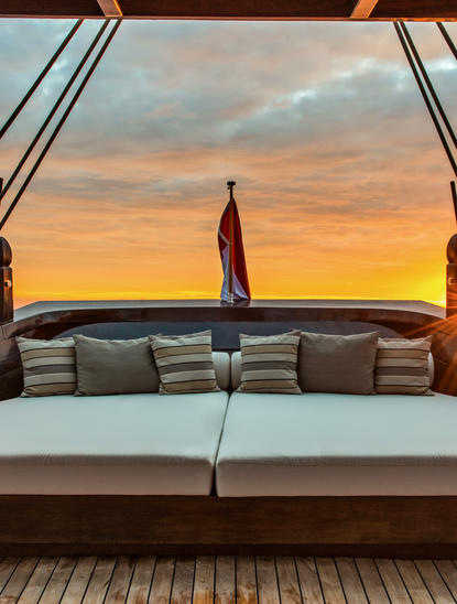 Sunrise view from Amandira's sundeck with lounge seating and ocean horizon.