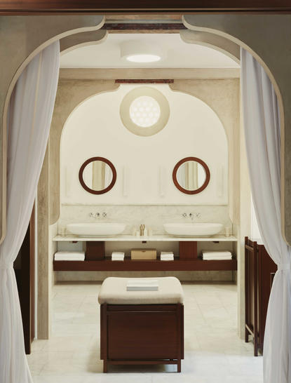 Dual marble sinks with brass fixtures in a Garden View Pavilion bathroom at Amanruya, Turkey.