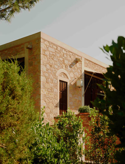 Amanruya pavilion exterior with stone facade and climbing ivy in Turkey.