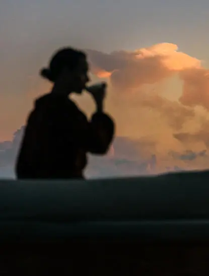 Silhouette of a photographer capturing the sunset sky at Amanyara resort.