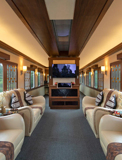 Train carriage at Amanjiwo resort with cream seating and warm lighting.