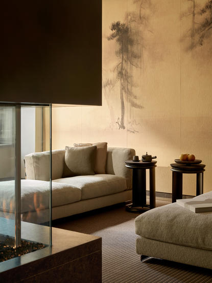 Corner Suite seating area at Aman New York with modern furnishings and floor-to-ceiling windows.