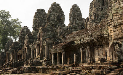 Ancient stone temple with towering carved pillars and weathered facades at Amansara.