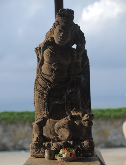 Wooden sculpture of stacked figures at Amankila resort, Bali.