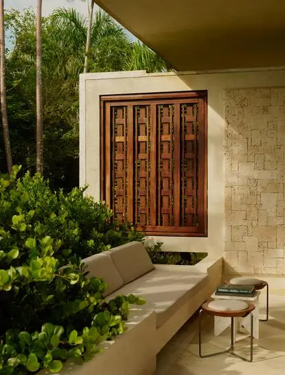 Casita entrance at Amanera with wooden door, stone walls, and tropical greenery.