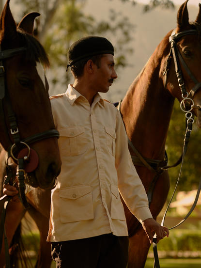 Guest leading horses during a jockey experience at Amanbagh, India.