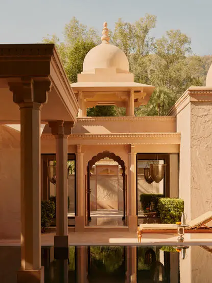 Pool pavilion exterior at Amanbagh with sandstone architecture and water feature.
