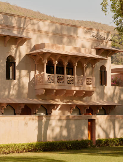 Terrace Haveli Suite exterior at Amanbagh, showing traditional Indian architecture with ornate stone balcony and arched windows.