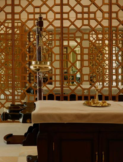 Wellness spa treatment room at Amanbagh with geometric latticed screens and massage bed.