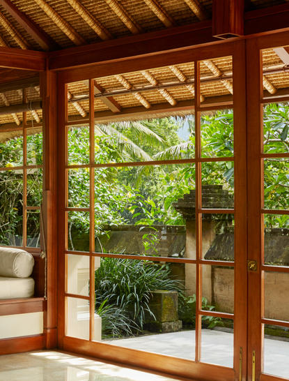 Duplex Pool Suite exterior at Amandari showing wooden pavilion with glass doors opening to tropical garden.