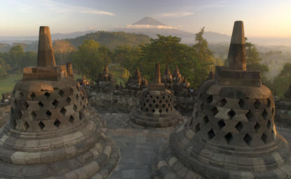 Borobudur temple at sunrise with mist-covered landscape, Amanjiwo, Indonesia.